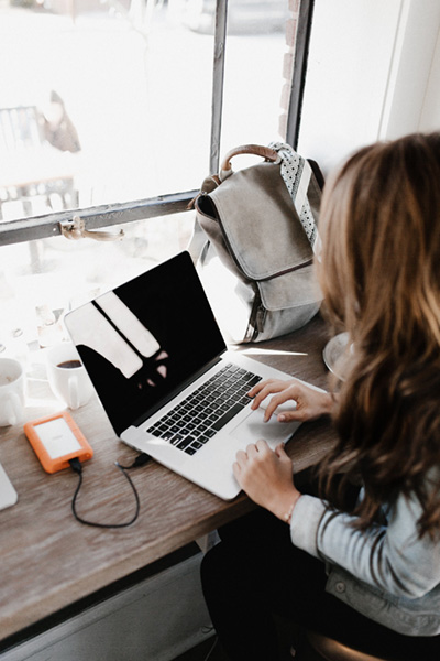 A woman at a desk using a laptop computer